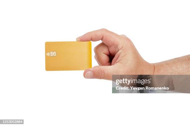 hand holding blank golden credit card with chip, isolated on white background - white shirt template stock pictures, royalty-free photos & images