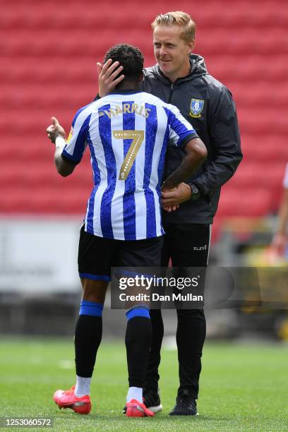 Garry Monk the Sheffield Wednesday manager congratulates Kadeem Harris following his side's 2-1 victory during the Sky Bet Championship match between...