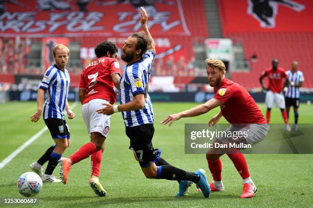 Atdhe Nuhin of Sheffield Wednesday falls under the challenge from Jay Dasila and Nathan Baker of Bristol City during the Sky Bet Championship match...