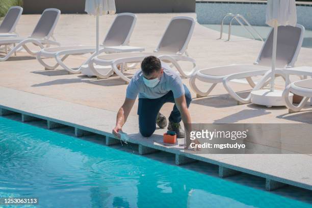 pool testing kit being used in a swimming pool - swimming pool stock pictures, royalty-free photos & images