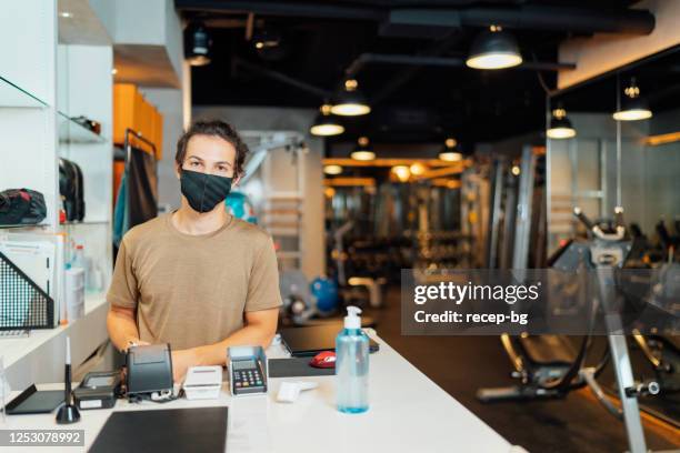 portrait of gym owner while wearing protective face mask at entrance - gym reopening stock pictures, royalty-free photos & images