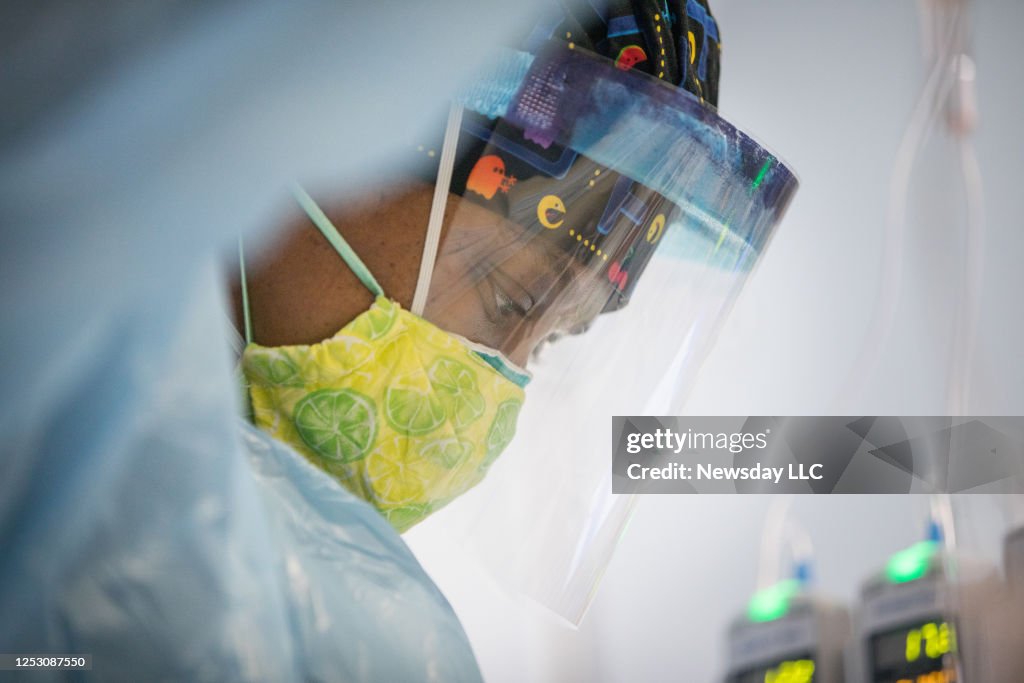 A Nurse in a Face Shield Tends to a COVID-19 Patient at a Hospital on Long Island, New York