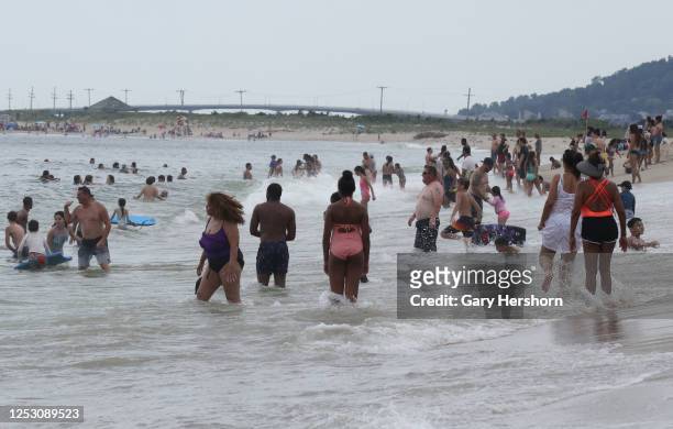 People swim in the Atlantic Ocean on a beach at Sandy Hook park at the Jersey Shore on June 27, 2020 in Middletown, New Jersey.