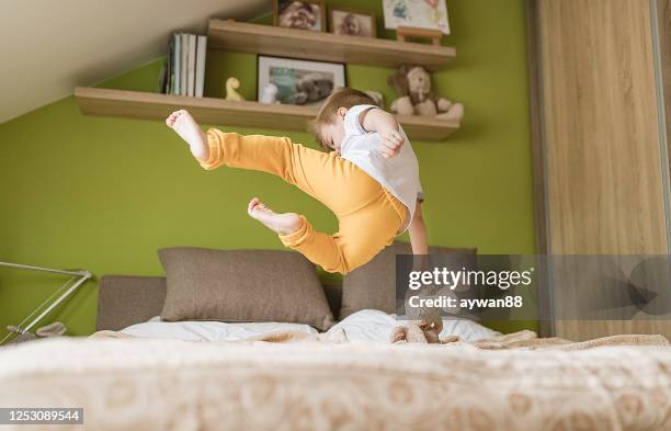 little boy jumping on the bed - ninja kid stock pictures, royalty-free photos & images