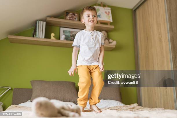 little boy jumping on the bed - ninja kid stock pictures, royalty-free photos & images