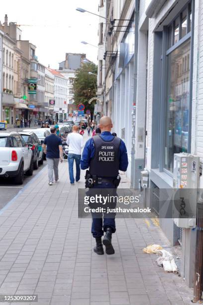 walking policeman in brussels - belgium police stock pictures, royalty-free photos & images
