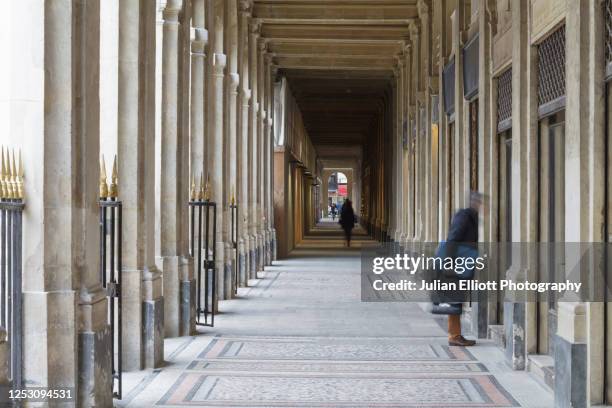 the arcades of the palais royal in paris. - palais royal stockfoto's en -beelden
