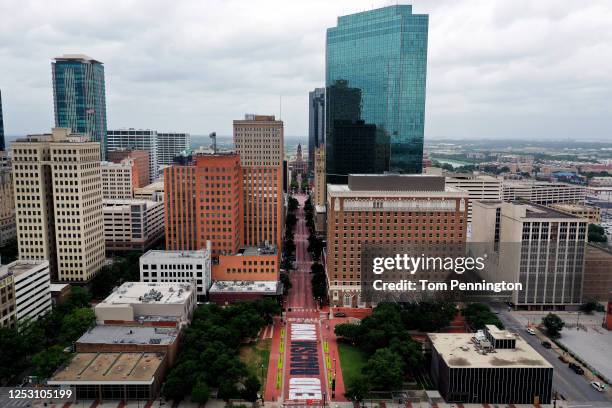 An aerial view from a drone as residents view the "End Racism Now" mural painted on Main Street in downtown on June 28, 2020 in Fort Worth, Texas....