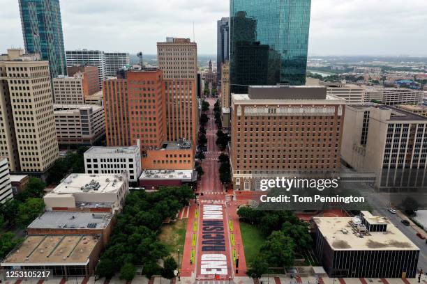 An aerial view from a drone as residents view the "End Racism Now" mural painted on Main Street in downtown on June 28, 2020 in Fort Worth, Texas....