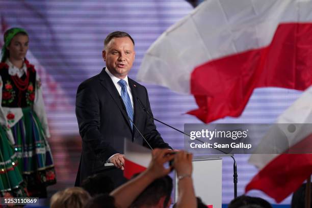 Polish President and member of the right-wing Law and Justice party Andrzej Duda speaks to supporters following initial results in the Polish...