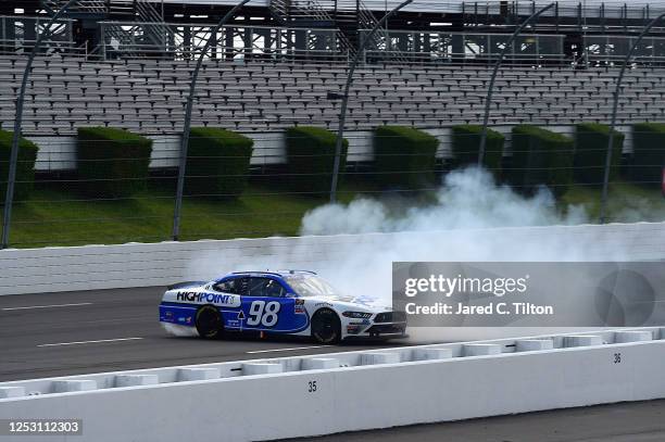 Chase Briscoe, driver of the Highpoint.com Ford, celebrates with a burnout after winning the NASCAR Xfinity Series Pocono Green 225 Recycled by J.P....