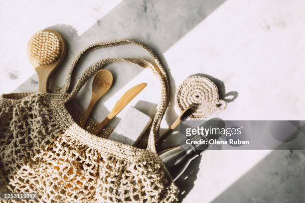 wicker bag with wooden kitchen appliances and others - washcloth stockfoto's en -beelden