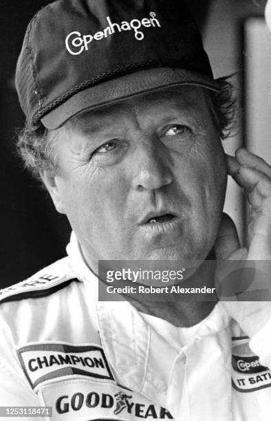 Driver A.J. Foyt stands in the speedway garage prior to the start of the 1985 Pepsi Firecracker 400 stock car race at Daytona International Speedway...