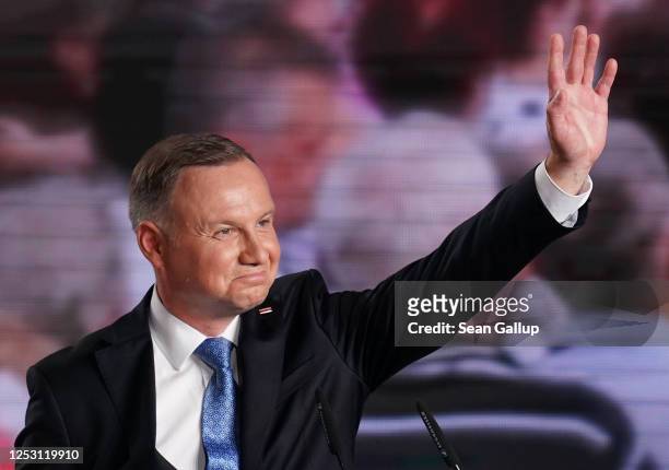 Polish President and member of the right-wing Law and Justice party, Andrzej Duda waves to supporters following initial results in the Polish...