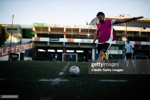 David Fernandez kicks the ball while playing an informal football match in a field with lines marked to keep distance on June 27, 2020 in Pergamino,...