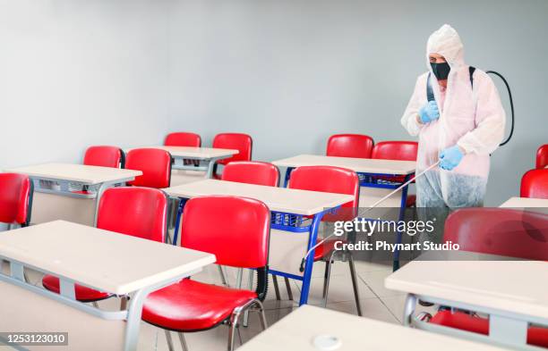 office disinfection during covid-19 pandemic - disinfection school stock pictures, royalty-free photos & images