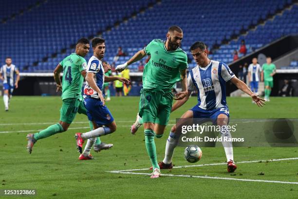 Karim Benzema of Real Madrid assists teammate Casemiro for their side's first goal during the Liga match between RCD Espanyol and Real Madrid CF at...