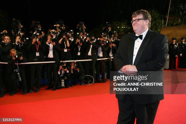 Director Michael Moore poses 19 May 2007 upon arriving at the Festival Palace in Cannes, southern France, for the screening of his film 'Sicko' at...