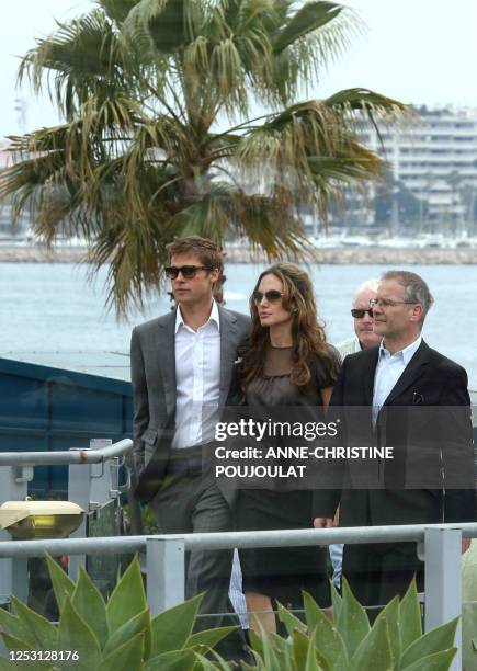 Actor and co-producer Brad Pitt, actress Angelina Jolie and British director Michael Winterbottom arrive 21May 2007 to attend a photocall for their...