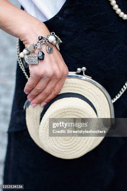 Cream colored hat raffia bag by Chanel as a detail of influencer Gitta Banko during a street style shooting on June 28, 2020 in Duesseldorf, Germany.