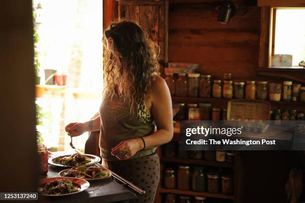 Weaverville, NC - April 22, 2023 Natalie Bogwalker, prepares lunch inside the kitchen she constructed. Bogwalker is the owner of Wild Abundance, an...