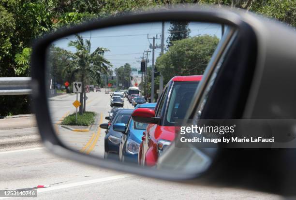 close-up of side-view mirror reflecting traffic - side view mirror foto e immagini stock