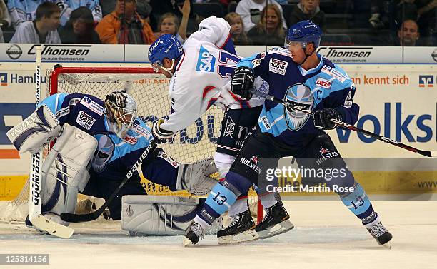 John Curry , goaltender of Hamburg saves the shot of Marcus Kink of Mannheim during the DEL match between Hamburg Freezers and Adler Mannheim at the...