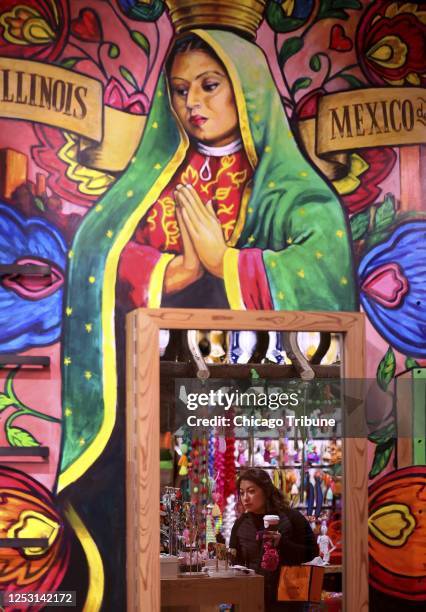Andrea Perez, of San Antonio, is reflected in a mirror while shopping at Colores Mexicanos on April 21, 2023.