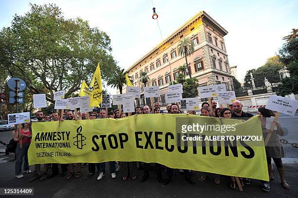 Amnesty International activists hold banners in support of Troy Davis in front of the US Embassy in Rome on September 16 during a protest to denounce...