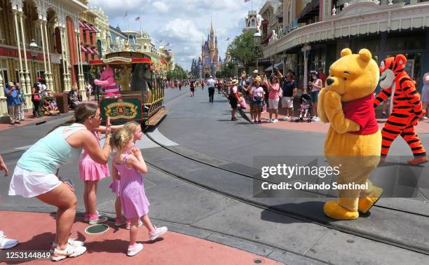 Young guests enjoy seeing Winnie The Pooh, and Tigger too, at the Magic Kingdom at Walt Disney World, in Lake Buena Vista, Florida, on May 17, 2021.