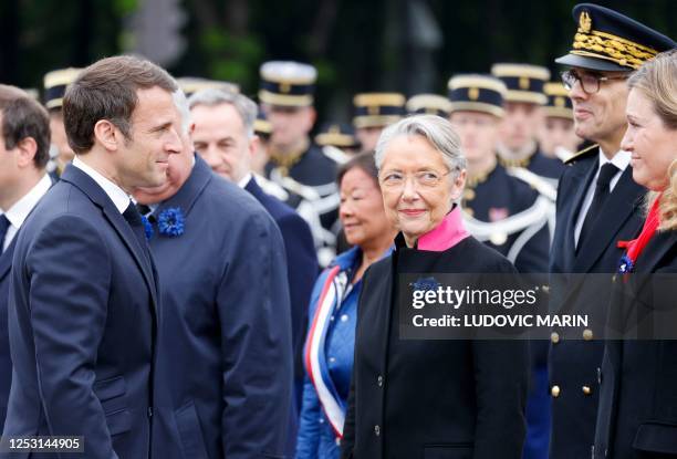 French President Emmanuel Macron is greeted by French Prime Minister Elisabeth Borne , French Police Prefect Laurent Nunez and French President of...