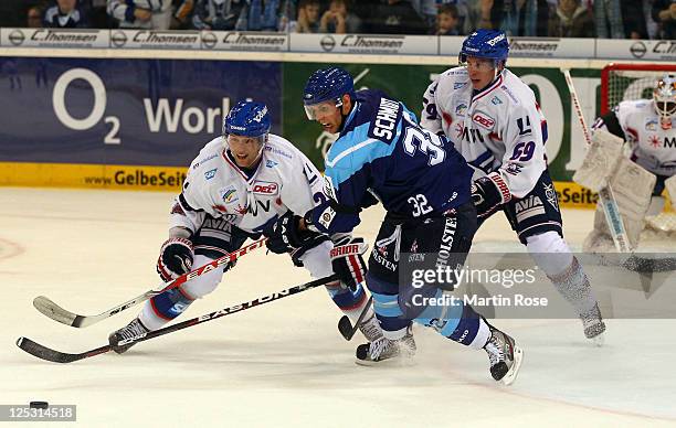 Kevin Schmidt of Hamburg vies for the puck with James Sifers of Mannheim during the DEL match between Hamburg Freezers and Adler Mannheim at the O2...