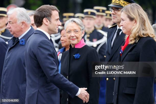 French President of the Senate, Gerard Larcher looks on as French President Emmanuel Macron speaks with French Prime Minister Elisabeth Borne and the...