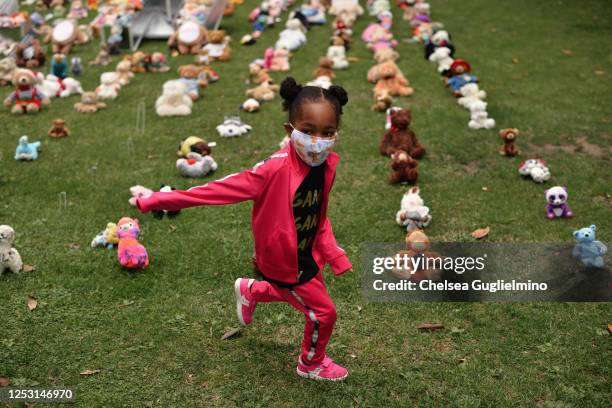 Child plays at BEAR THE TRUTH Protest: A Pop-Up Art Curation of Teddy Bears for Children and Families in honor of #BlackLivesMatter at Los Angeles...