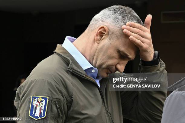 Mayor of the Ukrainian capital Kyiv, Vitali Klitschko, gestures as he examines high-rise residential building damaged by remains of a shot down...