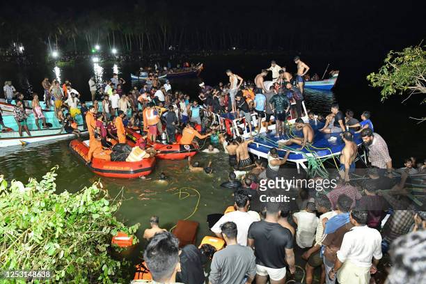 In this photograph taken on May 7 people carry out rescue operation at the site of a boat accident in Tanur, in Malappuram district of India's Kerala...