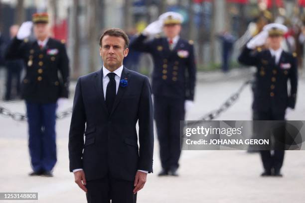 French President Emmanuel Macron pays his respects at the tomb of the unknown soldier at the Arc de Triomphe as he attends the ceremonies marking the...