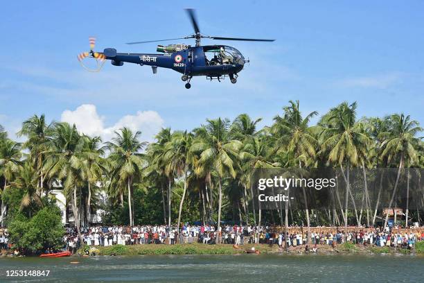 An Indian navy helicopter conducts a rescue operation at the site of a boat accident in Tanur, in Malappuram district on May 8, 2023. - At least 22...