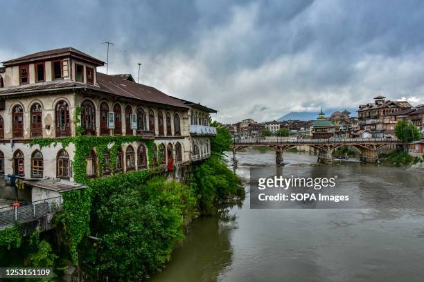 An ancient residential house is seen on the banks of river Jehlum during a cloudy weather in old city of Srinagar, the summer capital of Jammu and...