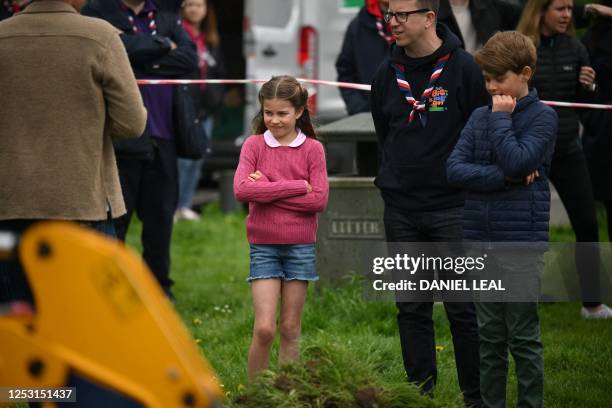 Britain's Princess Charlotte of Wales and Britain's Prince George of Wales watch Britain's Prince William, Prince of Wales as they all take part in...