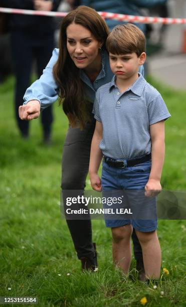 Britain's Catherine, Princess of Wales and Britain's Prince Louis of Wales watch Britain's Prince William, Prince of Wales as he uses an excavator...