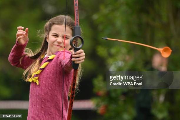 Princess Charlotte of Wales tries her hand at archery while taking part in the Big Help Out, during a visit to the 3rd Upton Scouts Hut in Slough on...
