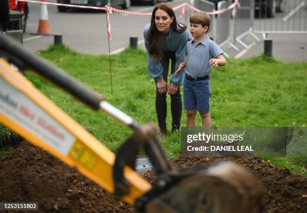 Britain's Catherine, Princess of Wales and Britain's Prince Louis of Wales watch Britain's Prince William, Prince of Wales as he uses an excavator...