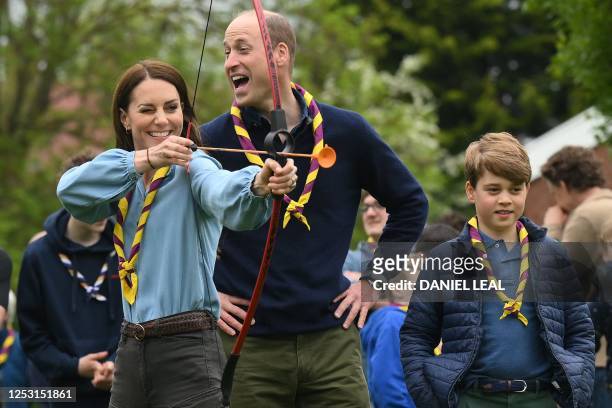 Watched by Britain's Prince William, Prince of Wales , Britain's Catherine, Princess of Wales, tries her hand at archery while taking part in the Big...