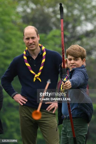 Watched by his father Britain's Prince William, Prince of Wales, Britain's Prince George of Wales tries his hand at archery while taking part in the...