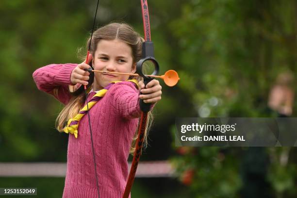 Britain's Princess Charlotte of Wales tries her hand at archery while taking part in the Big Help Out, during a visit to the 3rd Upton Scouts Hut in...