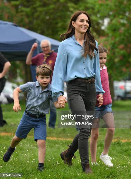 Prince Louis of Wales and Princess Charlotte of Wales walk with their mother, Catherine, Princess of Wales while taking part in the Big Help Out,...