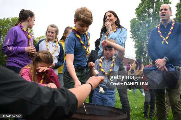Britain's Princess Charlotte of Wales shields her eyes as she and her brothers Britain's Prince George of Wales and Britain's Prince Louis of Wales...