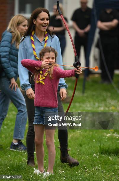 Watched by her mother Catherine, Princess of Wales, Princess Charlotte of Wales tries her hand at archery while taking part in the Big Help Out,...