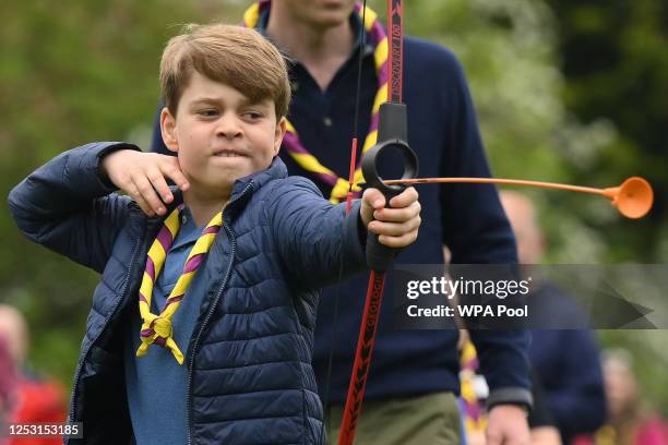 Prince George of Wales tries his hand at archery while taking part in the Big Help Out, during a visit to the 3rd Upton Scouts Hut in Slough on May...